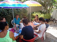 An advanced adult group in the garden with their teacher Chris in charge