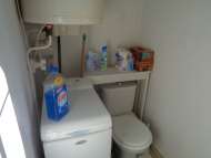Laundry with washing machine and hot water heater