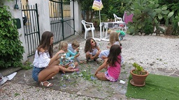 With the help of Linnea, 16 y.o, small girls are making flower wreaths for St Jean - the 21 of June