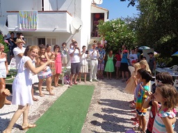 Children performing French songs to an adult audience of parents and other students